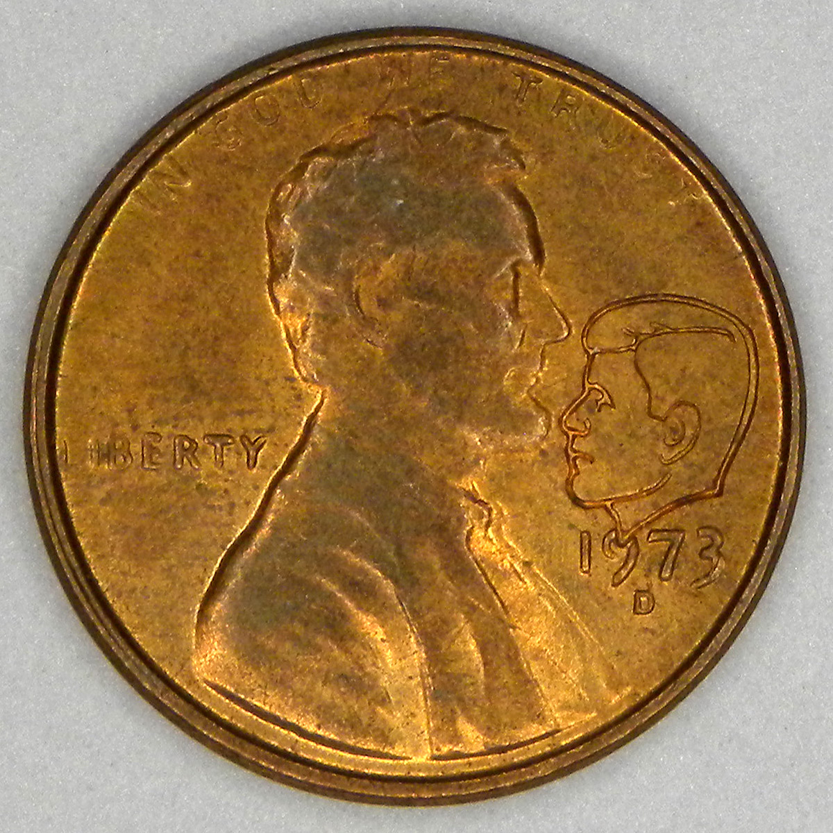 1973-D cent with added Kennedy portrait.